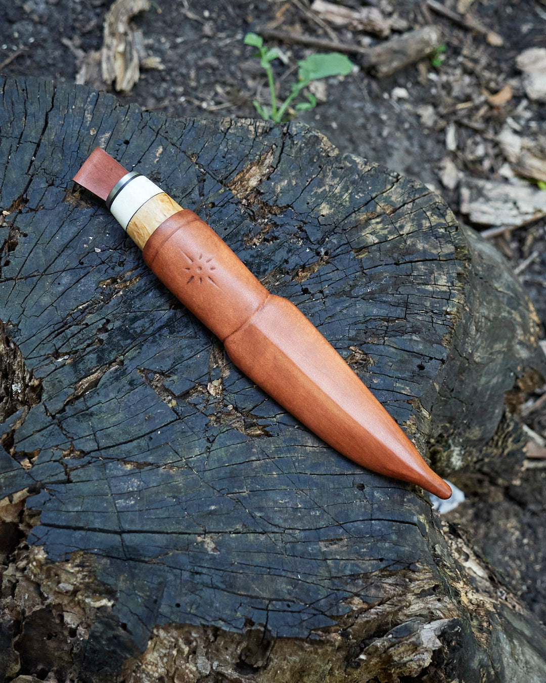 The hand made puukko, n690 blade, curly birch/antler handle, leather sheath.